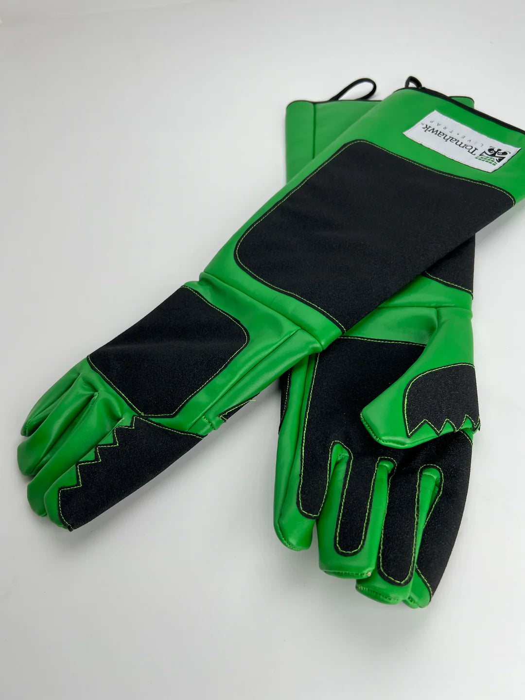 Dog standing on a smooth wooden floor inside a steel cage with a detachable tray and sturdy latches.